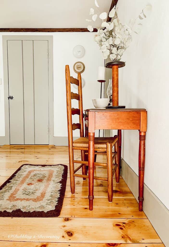 Ironstone covers on the wall with antique table, and rug.