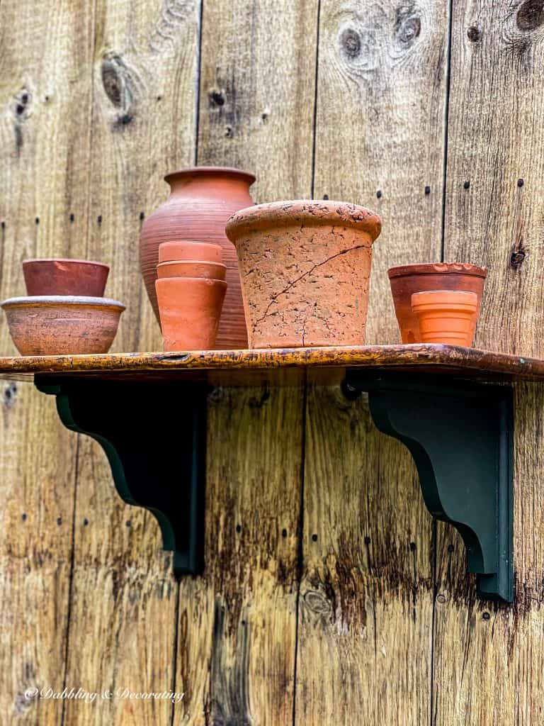 Outdoor DIY Planter Shelf with terracotta pots.