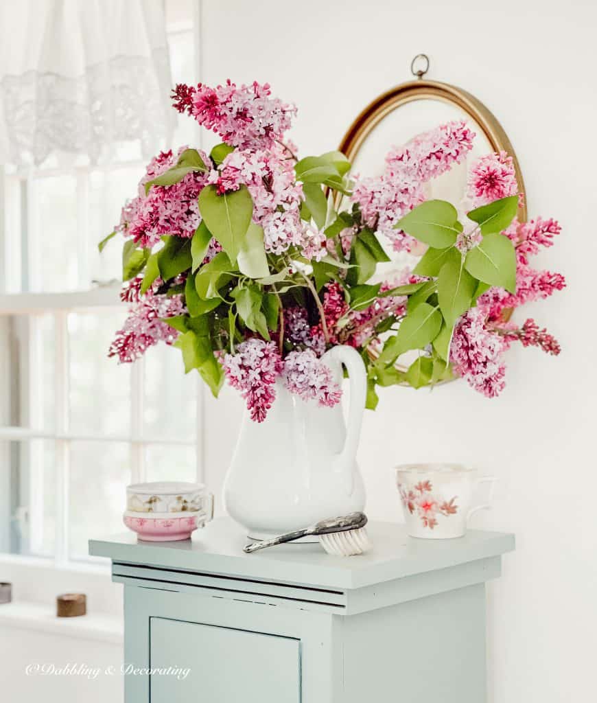 Lilacs on a blue cupboard in the bathroom.