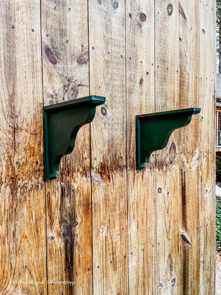 two green wooden shelf holders