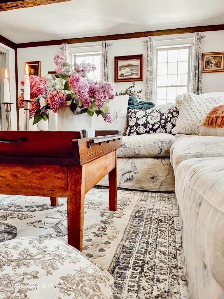 Spring purple flowers on coffee table in living room.