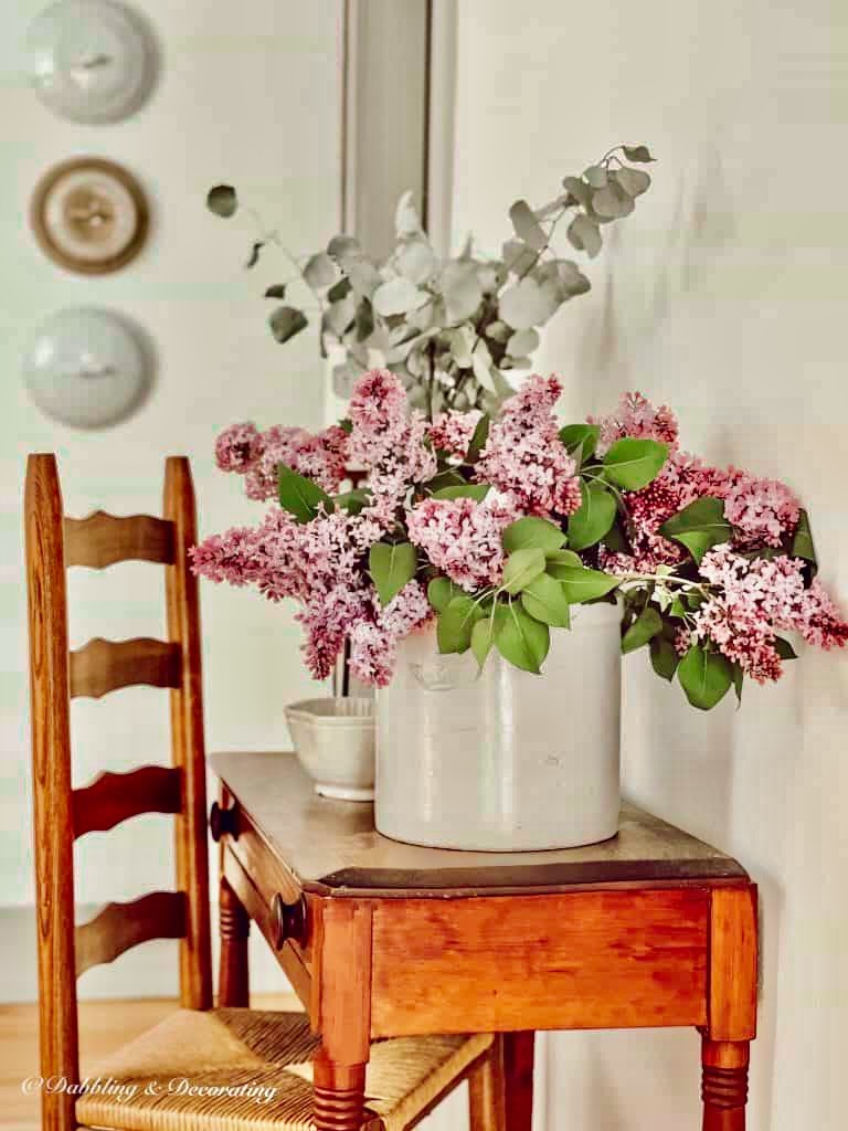 Lilacs in vintage Crock with Antique Table.