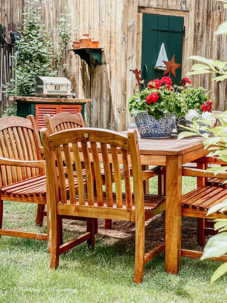 Our Summer House Tour backyard.  teak table and chairs.