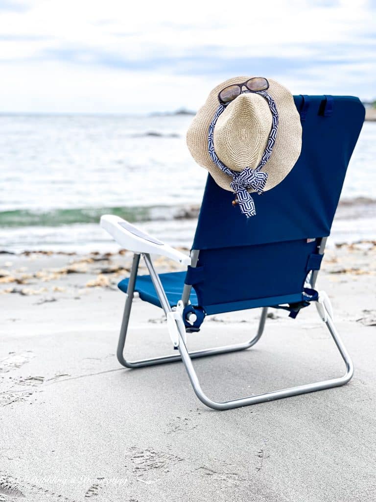 My Favorite Beach Day Essentials.  Beach chair with hat and sunglasses.