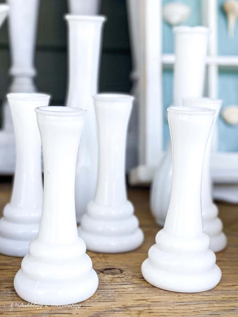 5 Clever Ways to Decorate with Yard Sale Finds.  Milk glass bud vases.