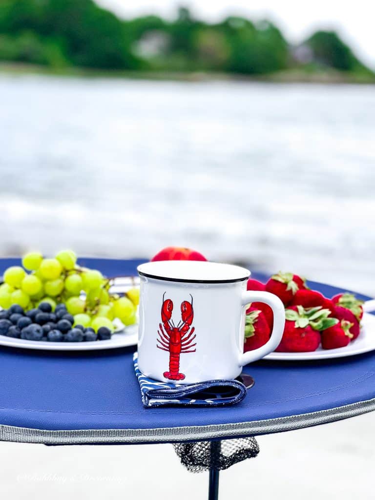 My Favorite Beach Day Essentials.  Lobster Mug and fruit.