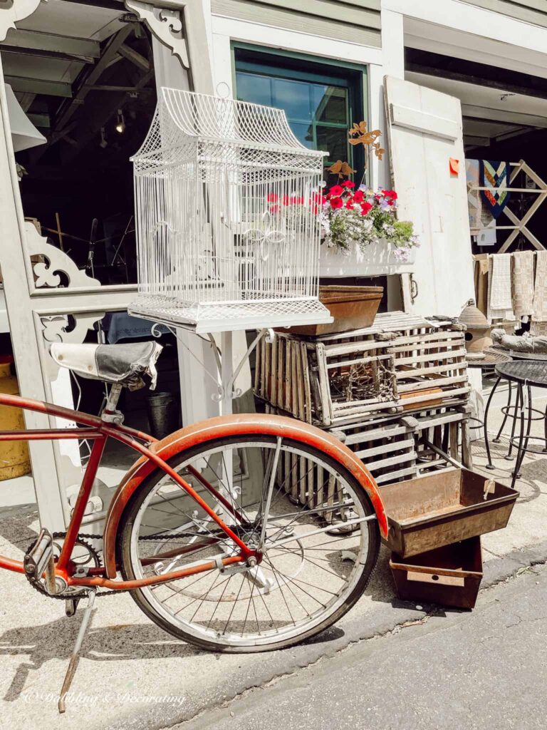 vintage red bicycle at antique store outdoors.