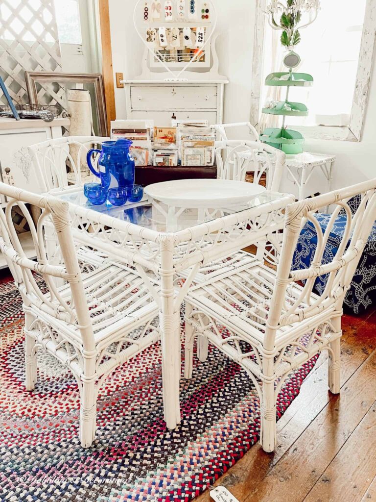 White wicker outdoor summer table setting at antique store.