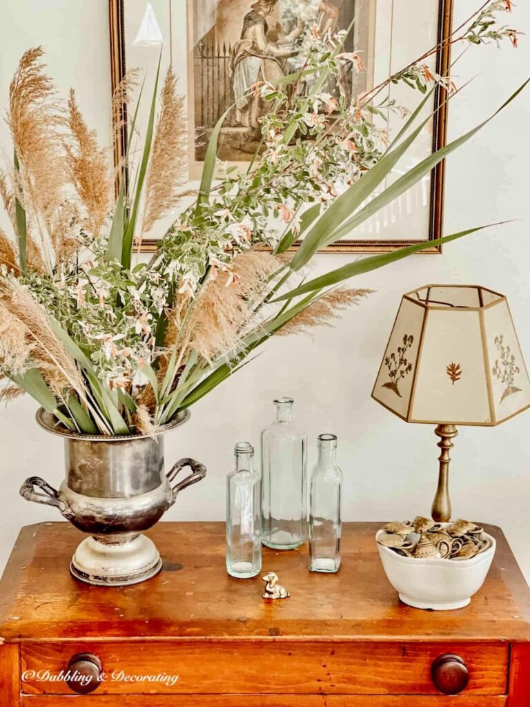 Summer New England wildflower arrangement ideas in vintage silver champagne bucket on antique wooden table.
