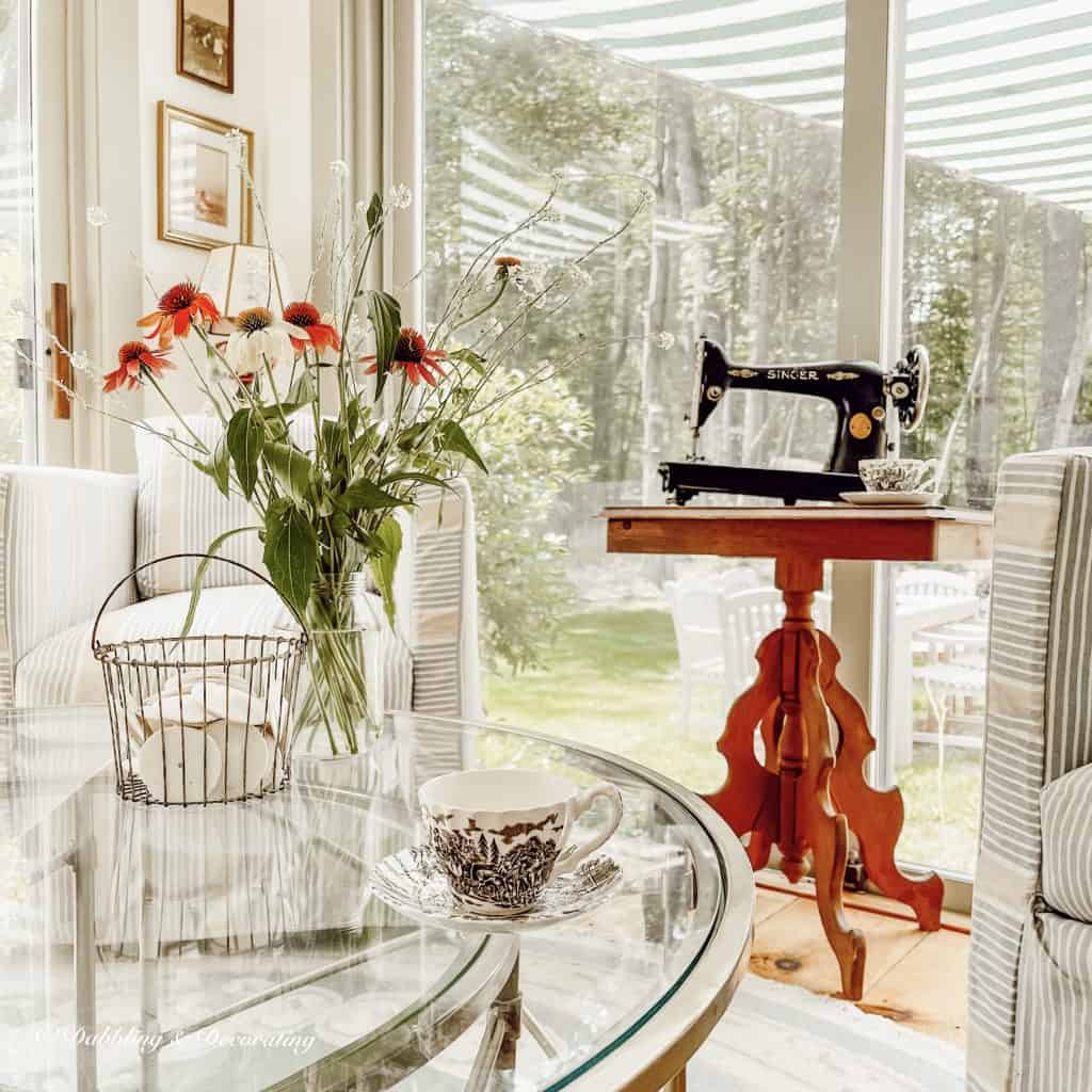 Vintage Sewing Machine on wooden table in sunroom.