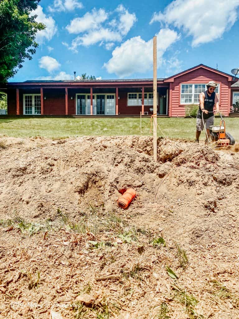 Man leveling dirt for a patio design.