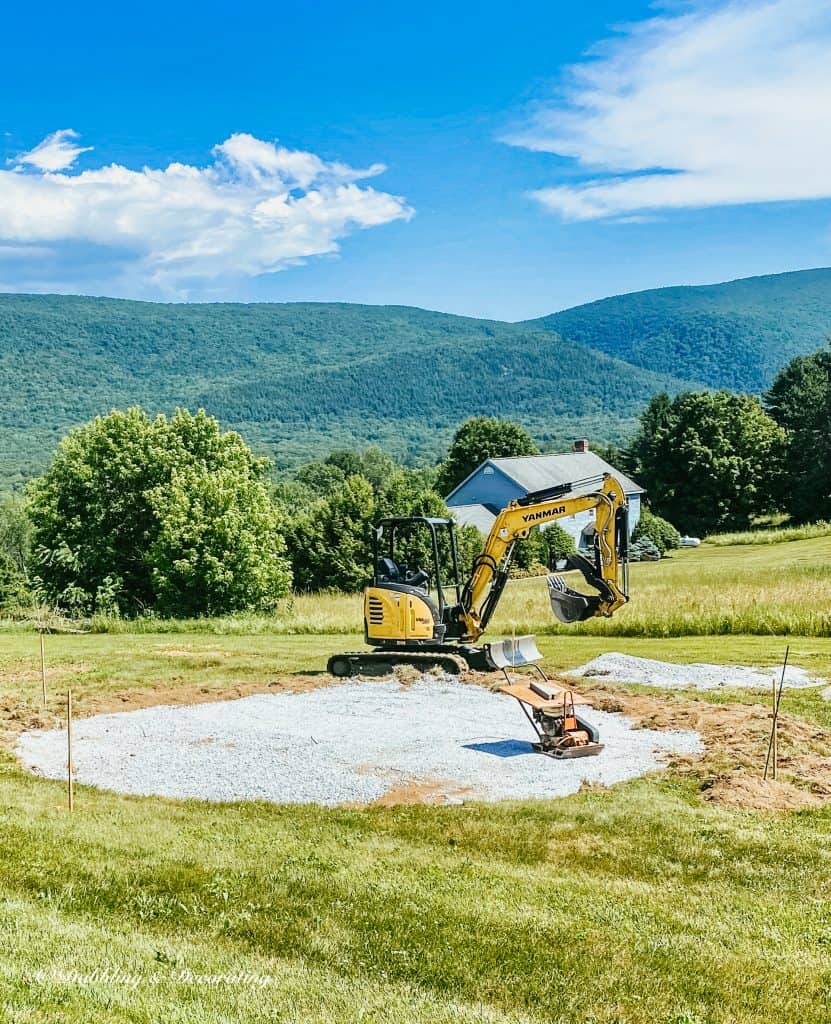 Outdoor living space with tractor installing patio