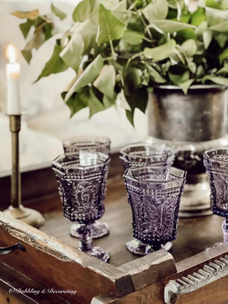 antique amethyst glassware on dark vintage wood table.