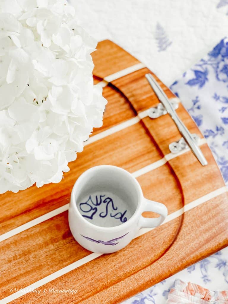 Nautical Serving Board with Mug and Flowers on Bed.