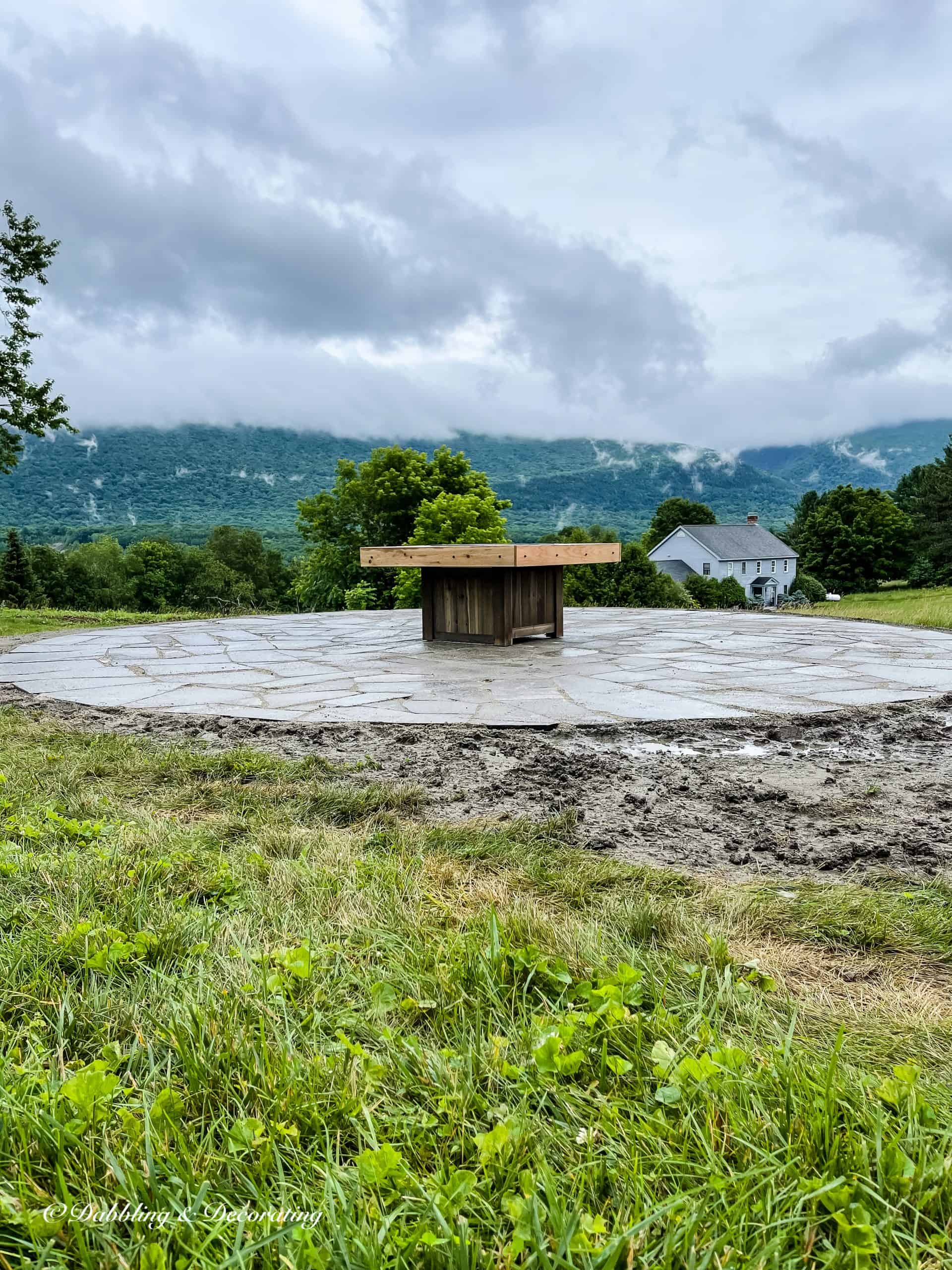 Backyard living project in the making with fire pit and stone patio.