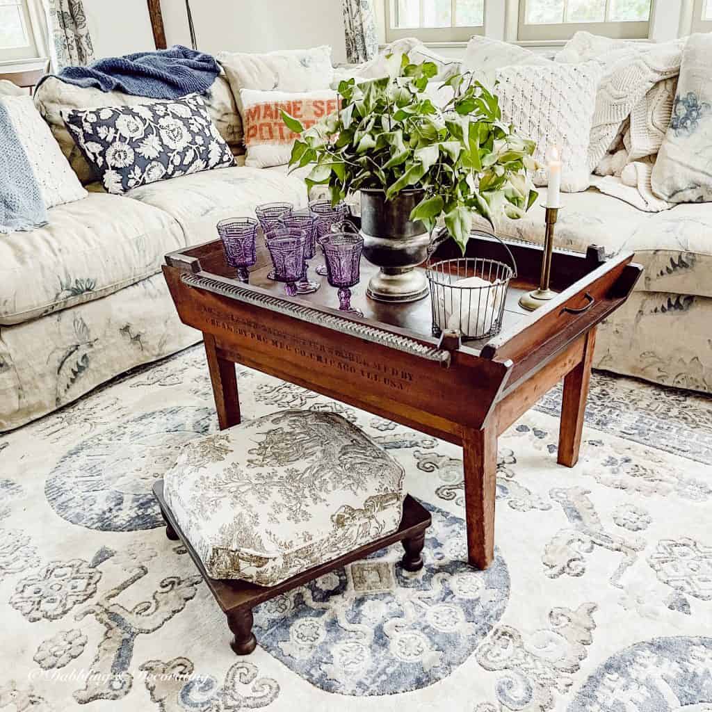 living room with antique coffee table and glasses.