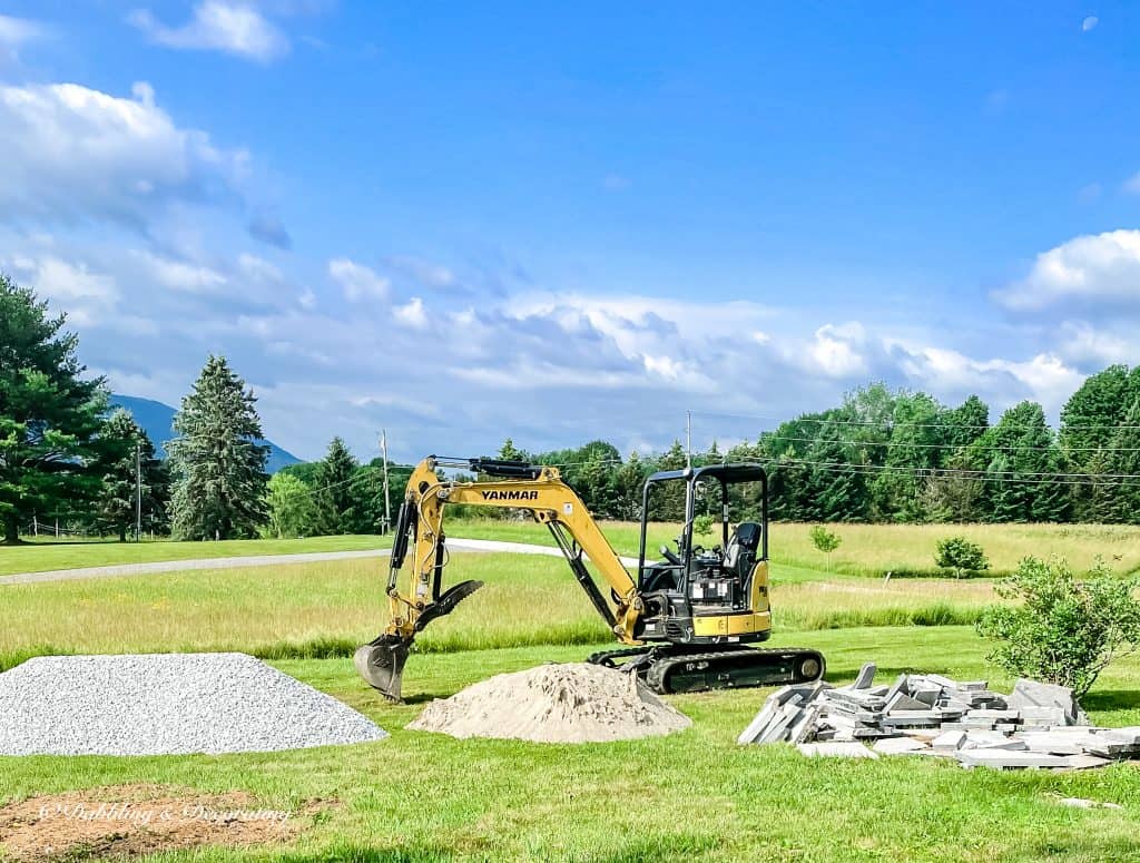 Tractor with patio supplies, stone, dirt and corinthian granite.