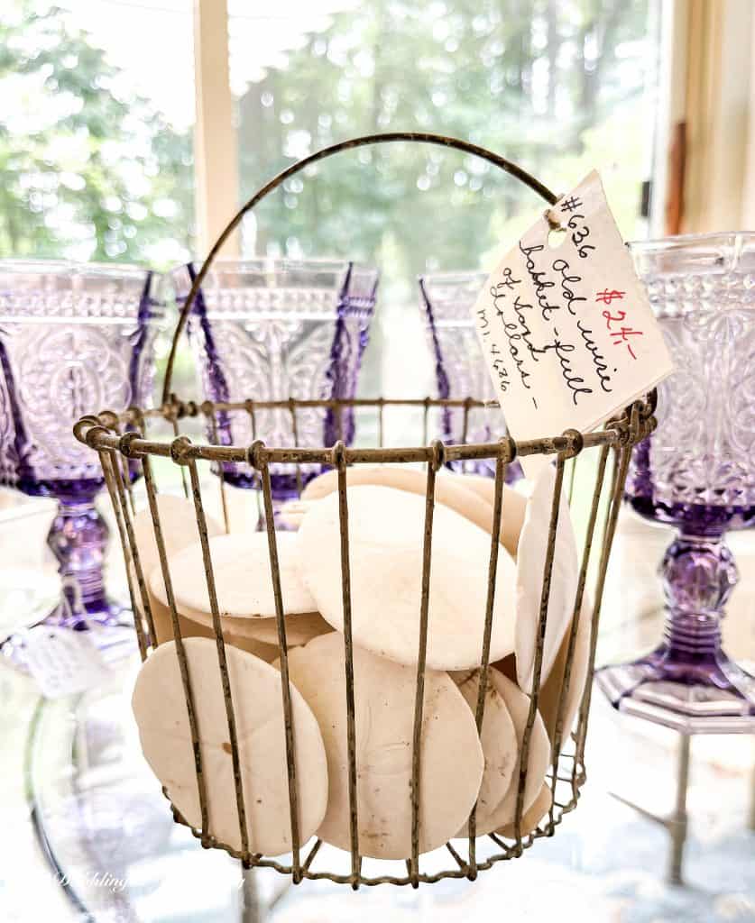 Basket of Sand Dollars with antique amethyst glassware