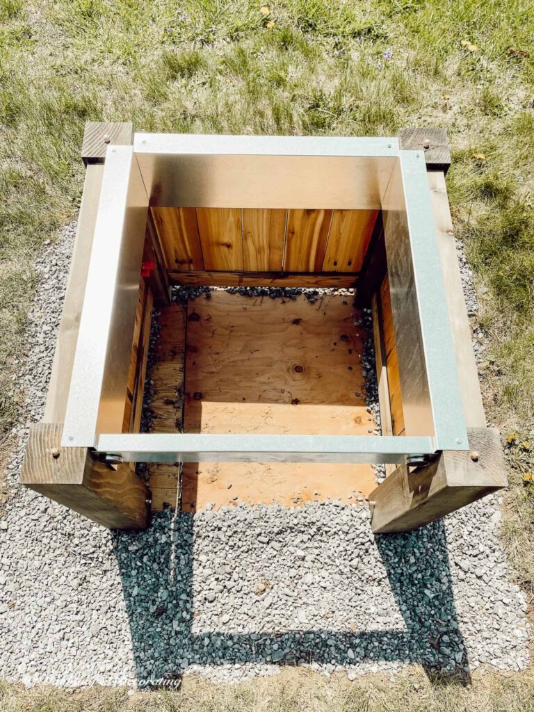 Wooden fire pit with open top looking down inside.