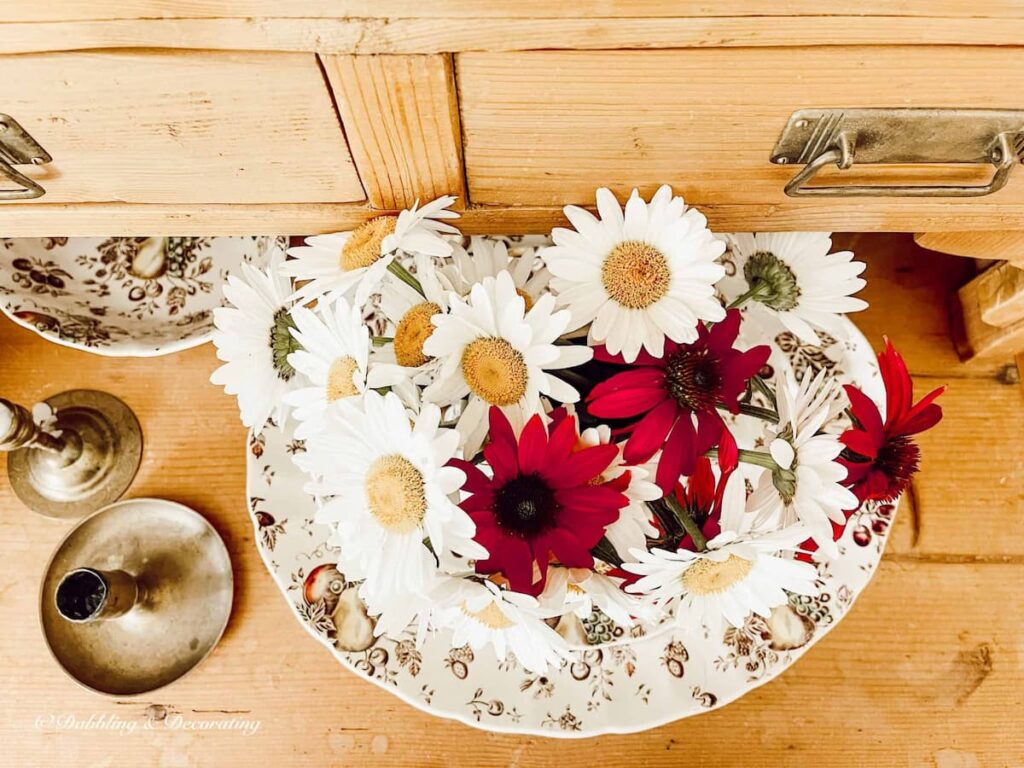 Johnson Brothers Autumn’s Delight- A Thrifted Dishware Set displayed with fall bouquet in vintage cabinet.