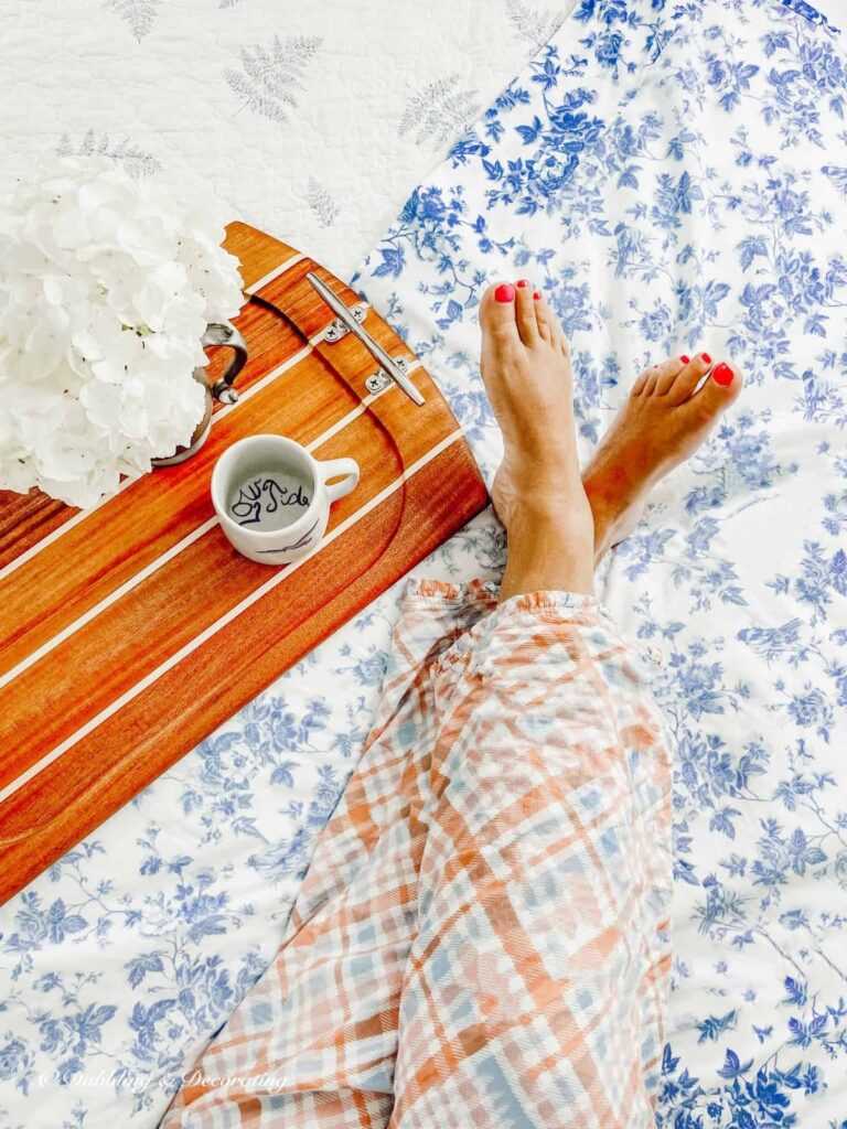 Nautical Serving Tray on Bed with Womans Legs kicked up.