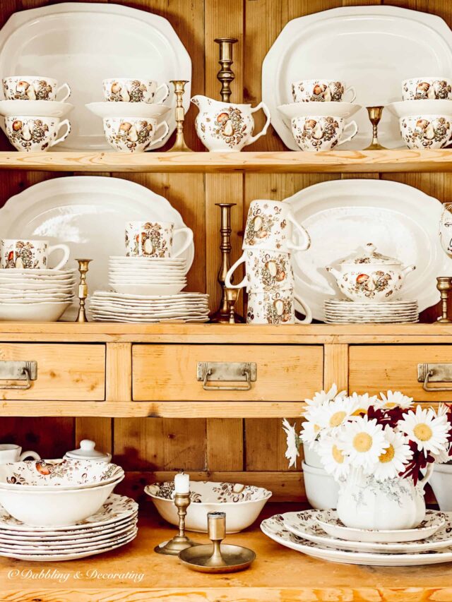 Autumn's Delight Johnson Brothers dinnerware displayed in vintage pine hutch.