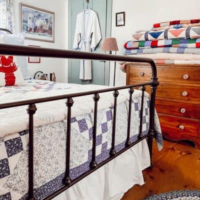 Bedroom with folded and displayed quilts
