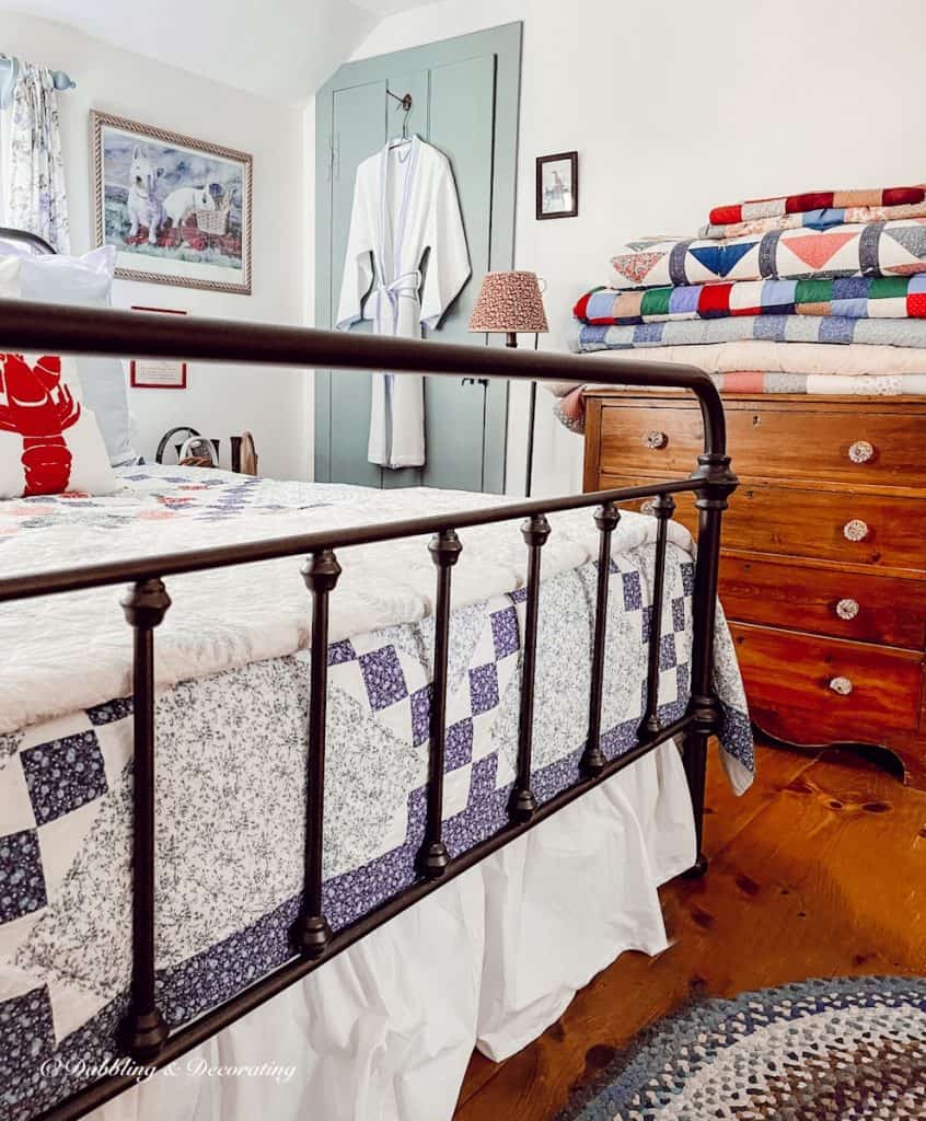 Bedroom with folded and displayed quilts