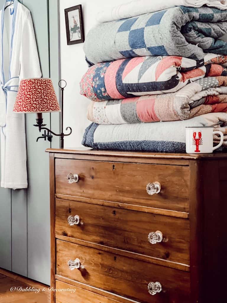 Folded Quilts on a Wooden Dresser