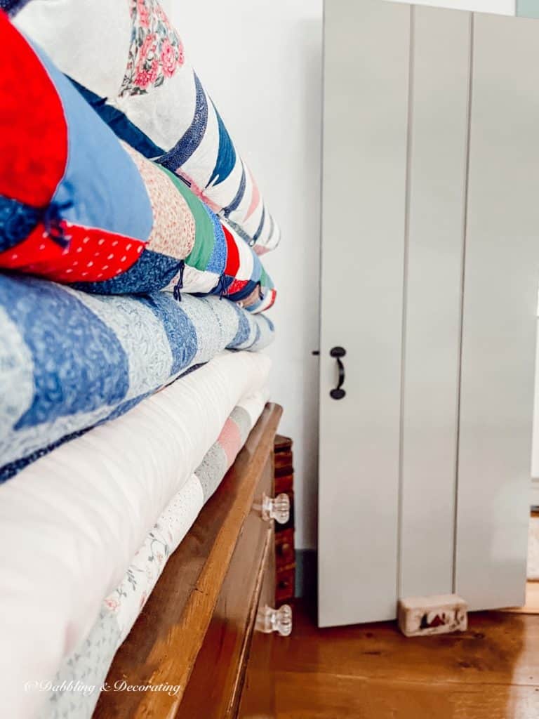 Folded Quilts  on a dresser.