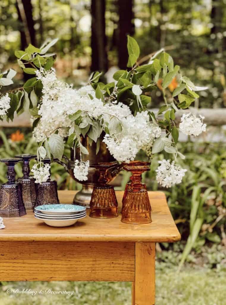 Vintage Table with hydrangea and colored glassware from second hand shops