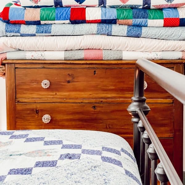 Folded Quilts on Wooden Dresser
