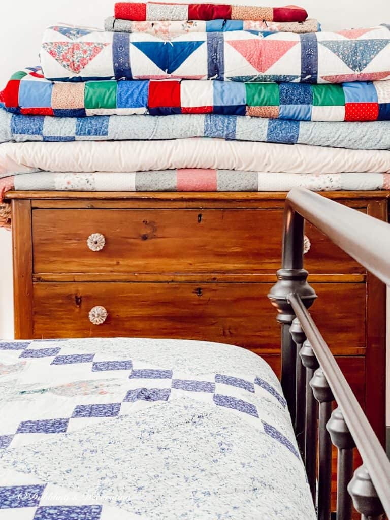 Folded Quilts on Wooden Dresser