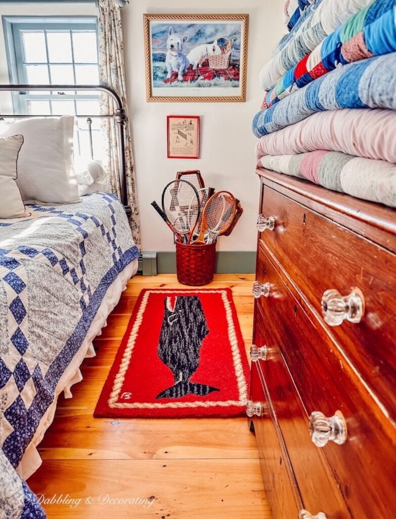 Basket of tennis racquets in vintage style guest bedroom.