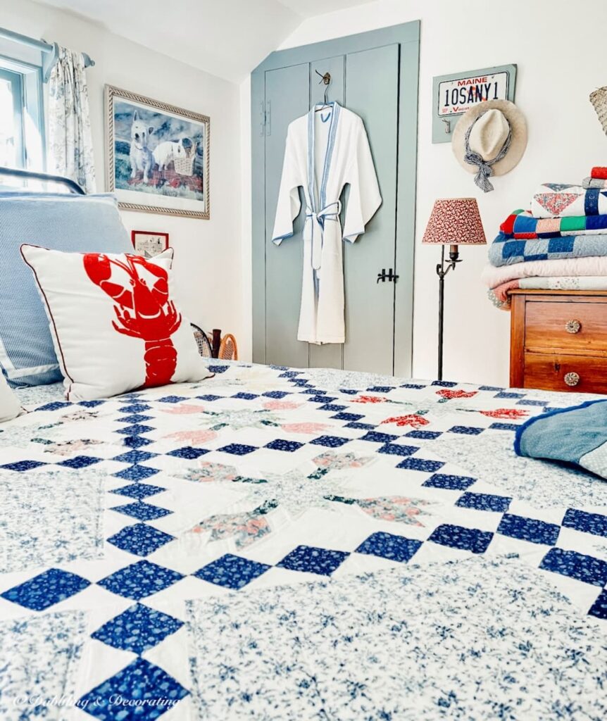 Heirloom quilt on bed in coastal bedroom.