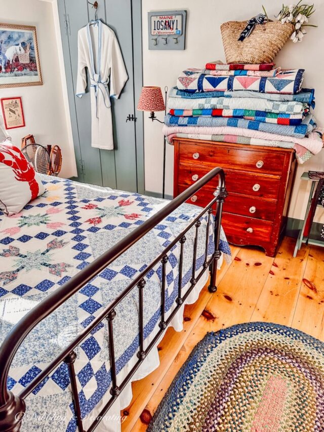 Quilts folded and displayed on bedroom dresser in vintage style small bedroom