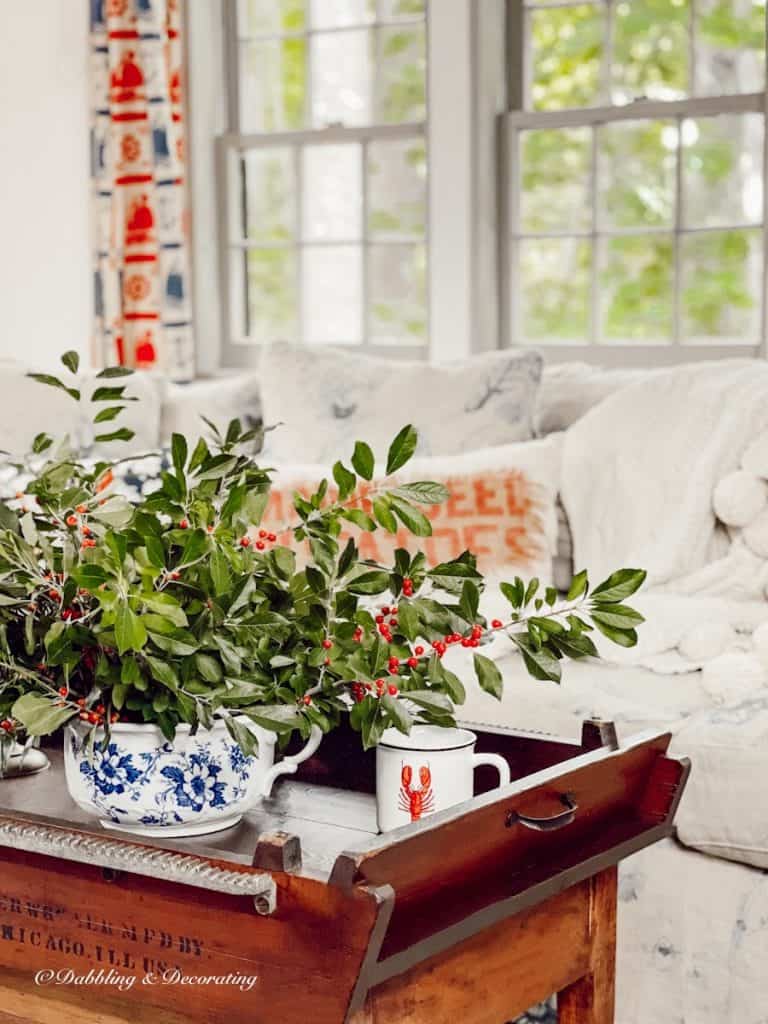 coffee table with winterberry in living room.