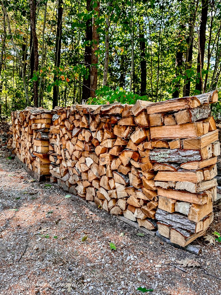 Pile of firewood in driveway of our Maine home.