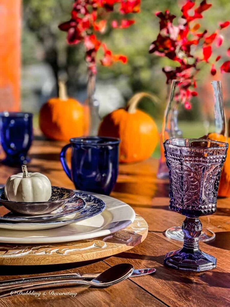 Outdoor Front porch decor ideas with colored glassware and cutlery.