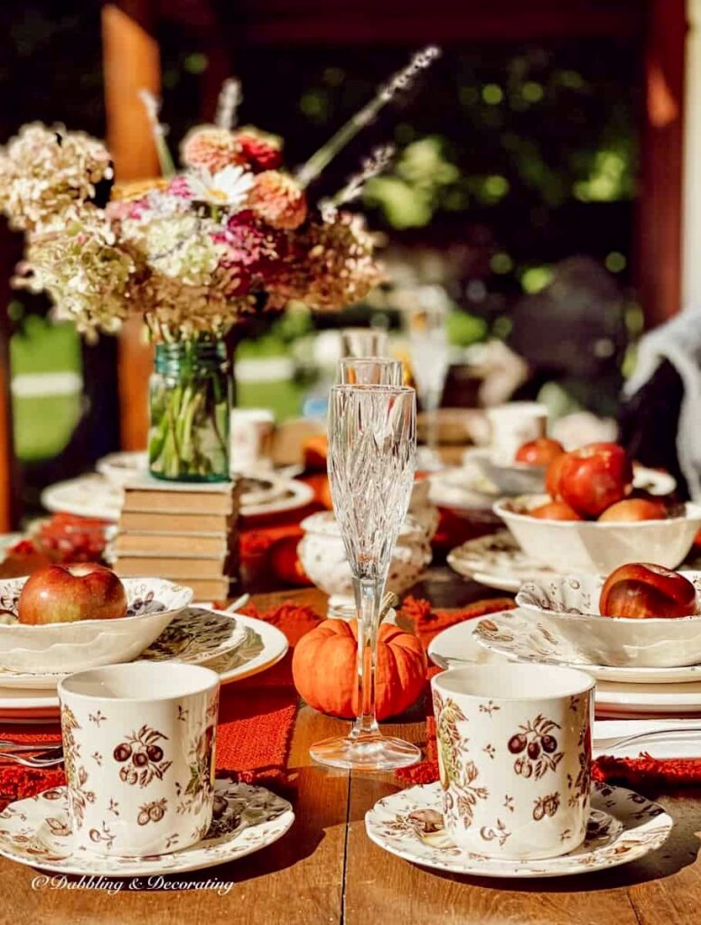 Outdoor fall table setting with Johnsons Brothers Autumn's Delight fall dinnerware pattern.