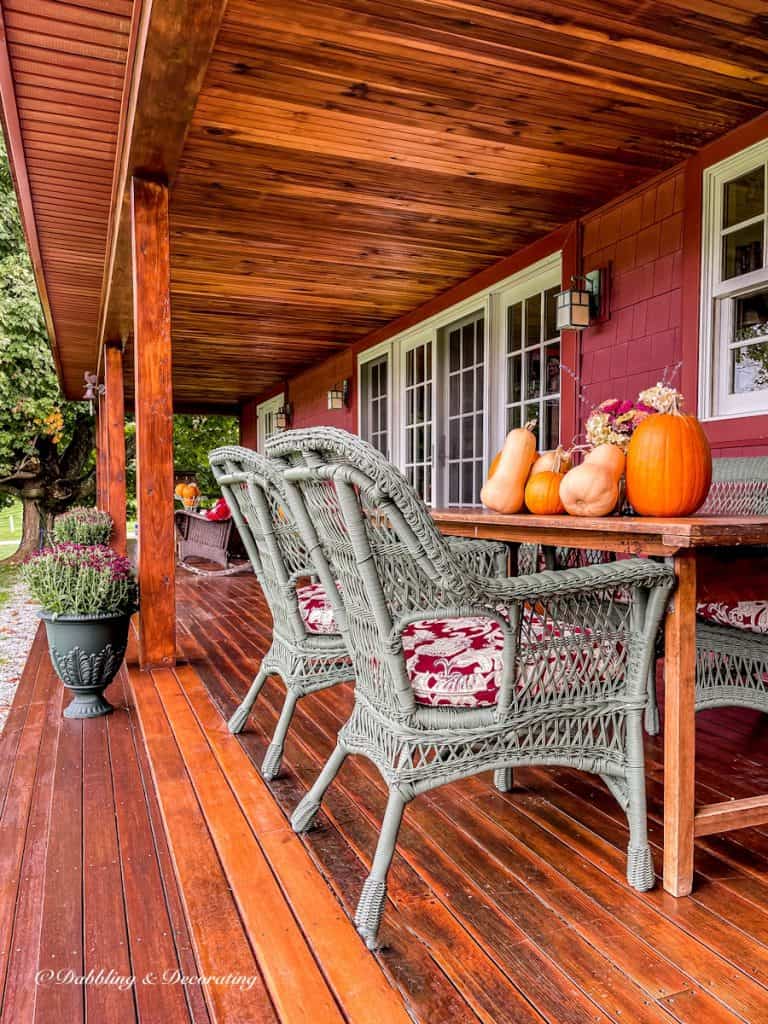 Long wooden porch with green urns