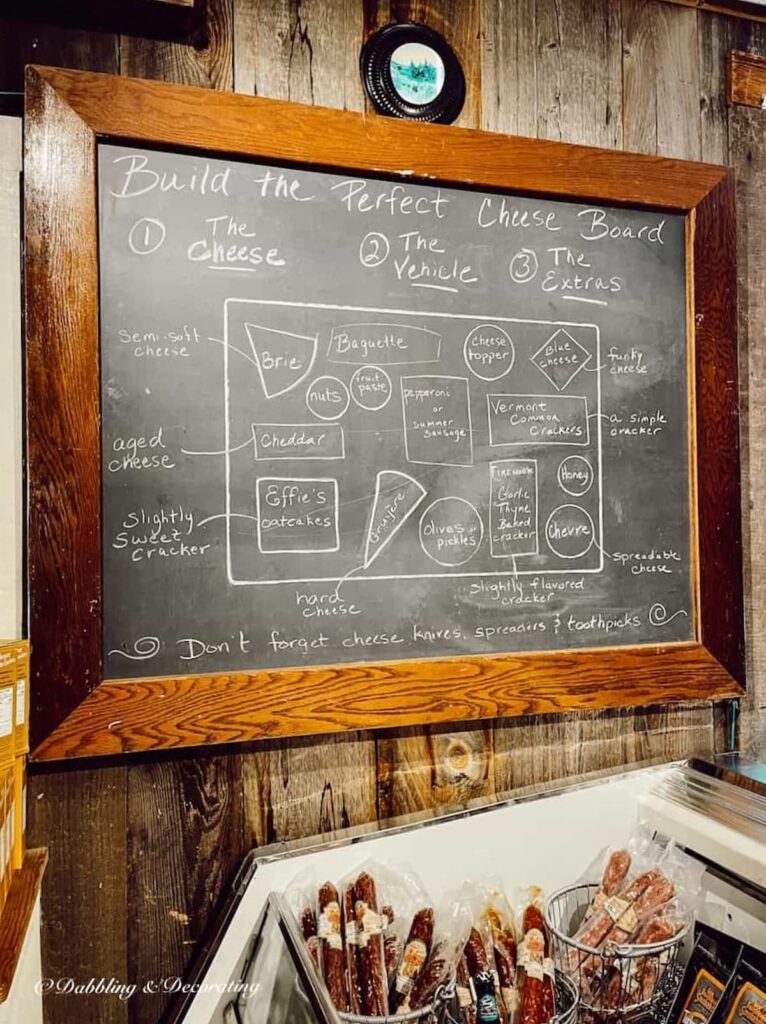 The Vermont Country Store "Make the Perfect Cheese board" formula on large chalkboard.