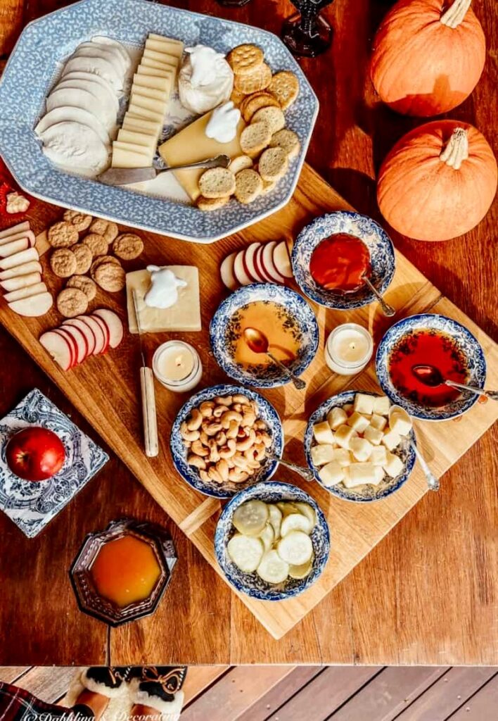 Vintage cheese board with vintage platter and fall decor.