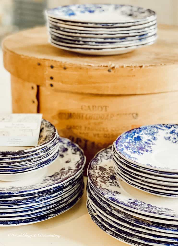 Antique blue and white dishes stacked around a crate at Vintage Market Days Vermont.
