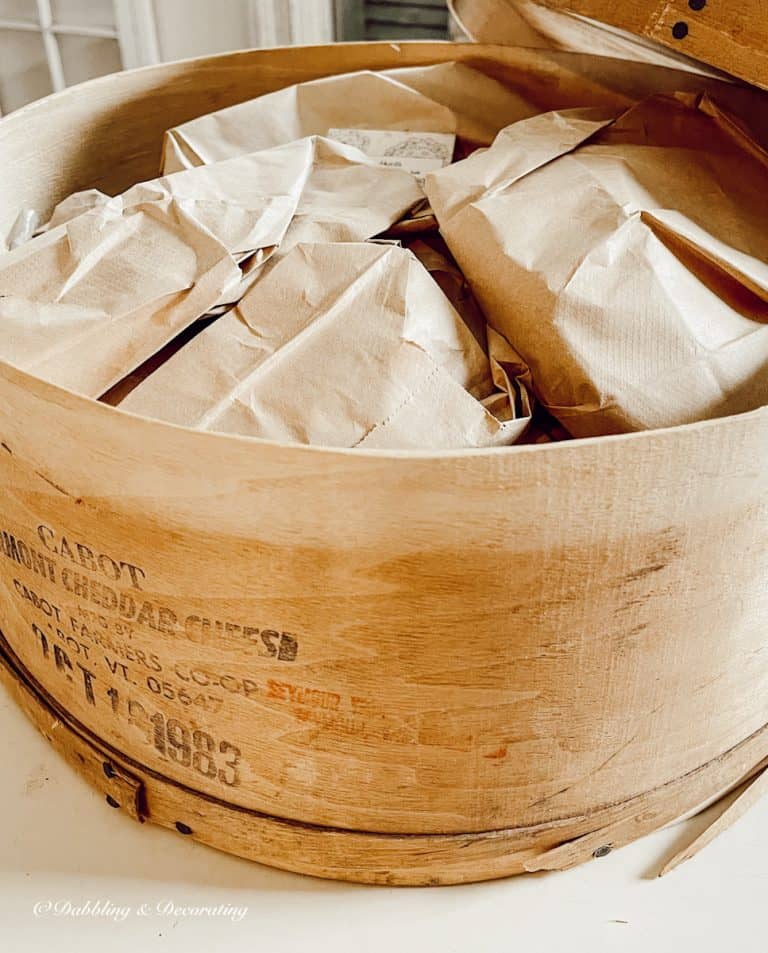 Crate packed with wrapped dishes at market.