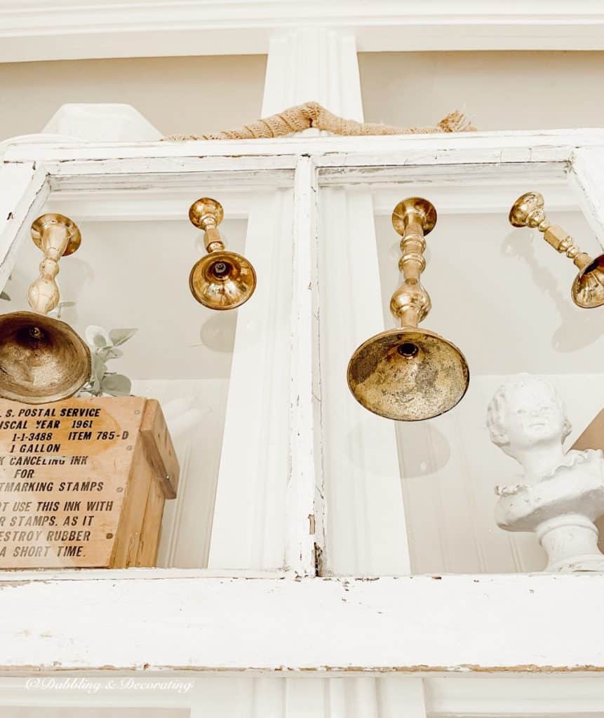 Salvaged Windows with hanging brass candlesticks