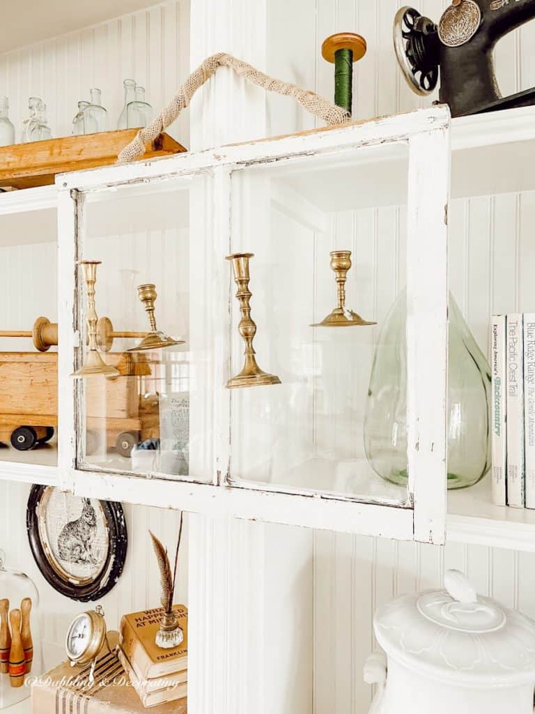 Salvaged Windows and Brass Candlesticks hanging.