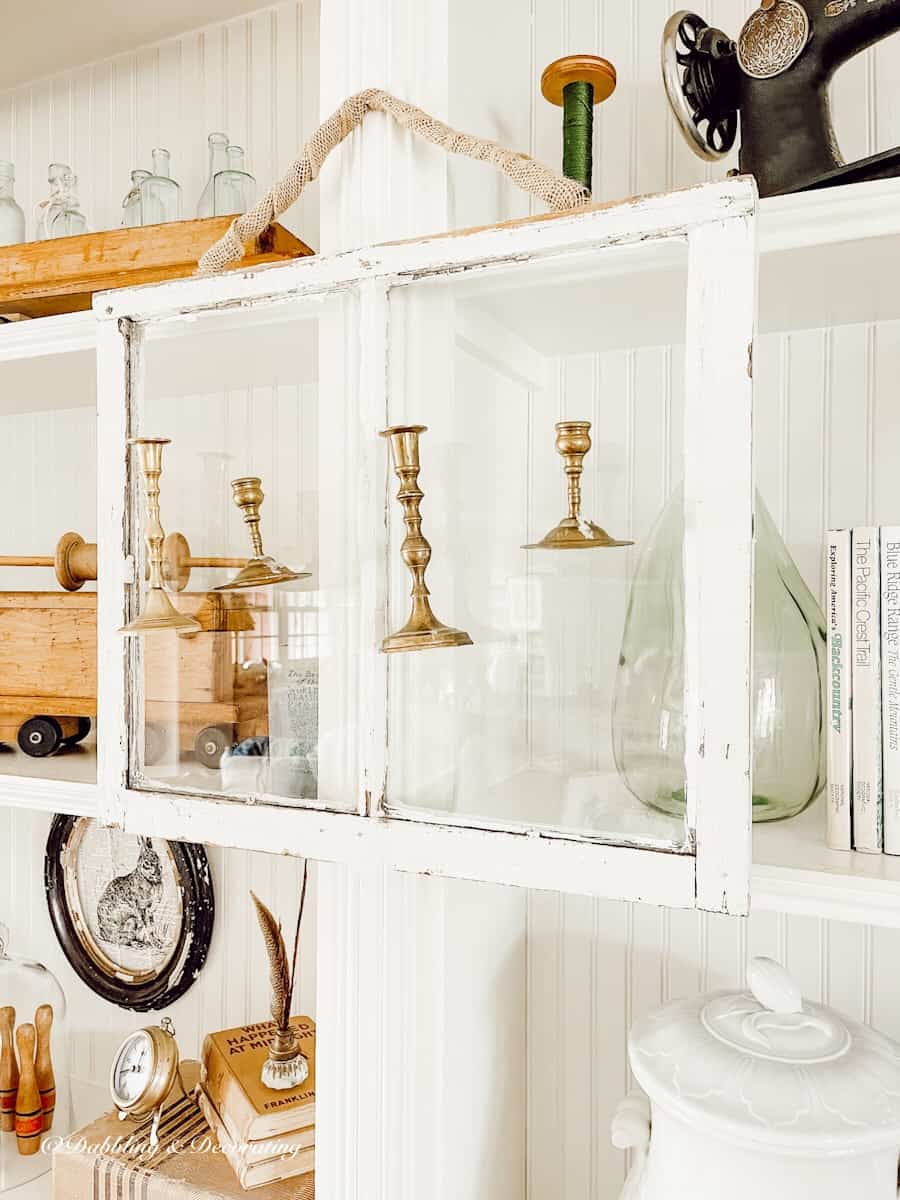 Salvaged Windows and Brass Candlesticks hanging.