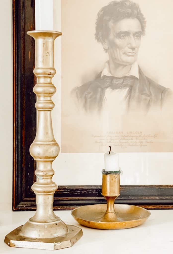 Vintage Abraham Lincoln Picture with Brass Candlesticks on Fireplace Built-ins