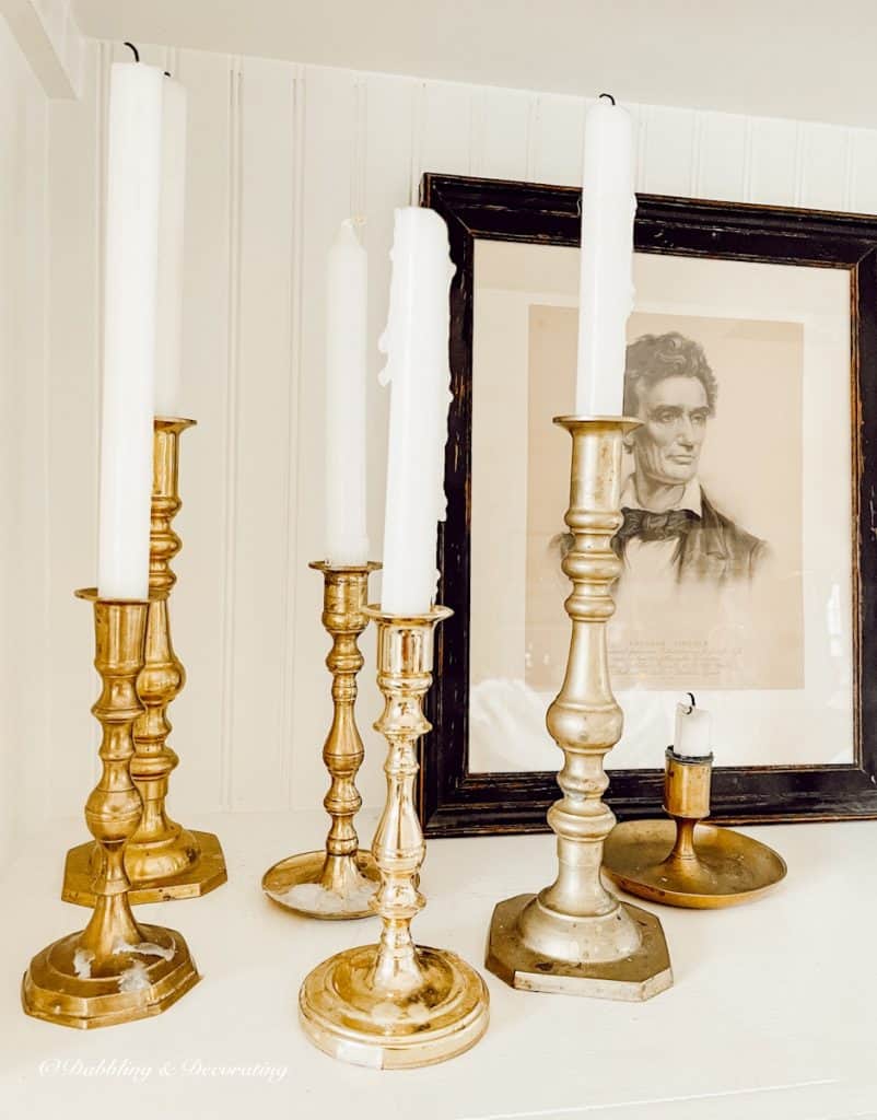 Vintage brass candlesticks on fireplace built-in shelving with Lincoln Picutre.